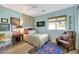 Serene bedroom featuring a light-colored bed and a bohemian armchair at 10032 Fox Springs Dr, Las Vegas, NV 89117