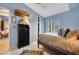 Spacious bedroom with a wooden post bed, ample closet space, and light blue walls at 10032 Fox Springs Dr, Las Vegas, NV 89117