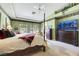 Large Primary bedroom with king bed, large TV, and views of the backyard at 10032 Fox Springs Dr, Las Vegas, NV 89117