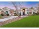 House exterior at sunset, showcasing landscaping and stone accents at 10032 Fox Springs Dr, Las Vegas, NV 89117