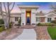 Elegant entryway with columns, a blue door, and landscaping at 10032 Fox Springs Dr, Las Vegas, NV 89117