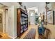 Hallway with hardwood floors, built-in bookcase, and decorative accents at 10032 Fox Springs Dr, Las Vegas, NV 89117