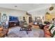 Open living area with hardwood floors, a large TV, and comfortable seating at 10032 Fox Springs Dr, Las Vegas, NV 89117