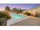 Inviting backyard oasis featuring a sparkling pool, ample patio space, and lush landscaping at 10032 Fox Springs Dr, Las Vegas, NV 89117