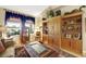 Cozy sitting room featuring built-in shelving and large windows at 10032 Fox Springs Dr, Las Vegas, NV 89117