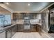 Modern kitchen featuring dark wood cabinets and granite countertops at 10352 Mint Leaves St, Las Vegas, NV 89183