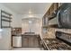 Kitchen features dark wood cabinets, granite countertops and stainless steel appliances at 10352 Mint Leaves St, Las Vegas, NV 89183