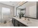 Double vanity bathroom with dark cabinets and large mirror at 11016 Calder Ave, Las Vegas, NV 89144