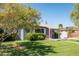 Gray Ranch style home with red door and large yard at 1206 Douglas Dr, Las Vegas, NV 89102