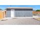 Detached gray garage with white door at 1206 Douglas Dr, Las Vegas, NV 89102