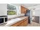 Kitchen features wood cabinets, a sink, and a view of living room at 1206 Douglas Dr, Las Vegas, NV 89102
