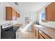 Kitchen with wood cabinets, stainless steel appliances, and tile floor at 1206 Douglas Dr, Las Vegas, NV 89102