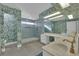 Elegant bathroom with dual sinks, walk-in shower, and patterned wallpaper at 1812 S 16Th St, Las Vegas, NV 89104