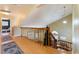 A hallway features hardwood floors, a wooden railing, and pendant lighting at 2112 Brighton Shore St, Las Vegas, NV 89128