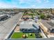 This aerial shows the property's backyard with a manicured lawn, play set, lounge chairs, and trampoline at 2690 Diamante Cir, Las Vegas, NV 89121