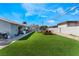 Backyard featuring artificial grass, outdoor dining area, and gas BBQ at 2690 Diamante Cir, Las Vegas, NV 89121