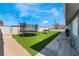 Backyard featuring artificial grass, trampoline, and outdoor seating area at 2690 Diamante Cir, Las Vegas, NV 89121