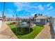 Backyard featuring artificial grass, trampoline, and outdoor seating area at 2690 Diamante Cir, Las Vegas, NV 89121