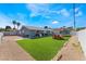 Spacious backyard featuring artificial grass, outdoor dining area, and privacy fencing at 2690 Diamante Cir, Las Vegas, NV 89121