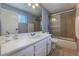 Well-lit bathroom with a sink, large mirror, and a shower with glass doors at 2690 Diamante Cir, Las Vegas, NV 89121