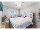 The bright bedroom is designed with a ceiling fan, a silver bed frame and bright windows at 2690 Diamante Cir, Las Vegas, NV 89121