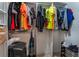 Organized walk-in closet with hanging clothes, vacuum, and shoe rack at 2690 Diamante Cir, Las Vegas, NV 89121
