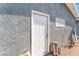 Exterior view of a property with a white door, providing access to the home at 2690 Diamante Cir, Las Vegas, NV 89121