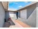 Inviting front entrance featuring a blue door, decorative shutters, and tidy landscaping at 2690 Diamante Cir, Las Vegas, NV 89121