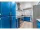 The kitchen is equipped with stainless steel appliances, blue cabinets and a contemporary range hood at 2690 Diamante Cir, Las Vegas, NV 89121