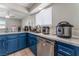 This kitchen is designed with blue cabinets, modern appliances, and ample counter space at 2690 Diamante Cir, Las Vegas, NV 89121
