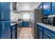 This modern kitchen features sleek stainless steel appliances and elegant blue cabinets at 2690 Diamante Cir, Las Vegas, NV 89121