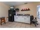 Efficient kitchenette with white cabinets, a microwave, and a small refrigerator for convenience at 2690 Diamante Cir, Las Vegas, NV 89121