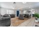 Open-concept living area with tile floors, contemporary furnishings, and a view to the dining room at 2690 Diamante Cir, Las Vegas, NV 89121