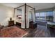 Main bedroom with four-poster bed and city views at 3111 Bel Air Dr # 20H, Las Vegas, NV 89109