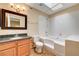 Bathroom with granite vanity, tiled walls, and a bathtub at 3145 E Flamingo Rd # 2122, Las Vegas, NV 89121