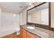 Bathroom with granite countertop, large mirror, and shower/tub combo at 3145 E Flamingo Rd # 2122, Las Vegas, NV 89121