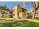 Tan two-story building with grassy lawn and mature trees at 3145 E Flamingo Rd # 2122, Las Vegas, NV 89121