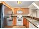 Kitchen features white appliances and wood cabinets at 3145 E Flamingo Rd # 2122, Las Vegas, NV 89121