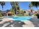 Community pool with palm trees and surrounding patio at 3145 E Flamingo Rd # 2122, Las Vegas, NV 89121