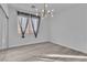 Spacious bedroom with gray floors and a modern chandelier at 35 Moraine Dr, Henderson, NV 89052