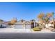 Two-story house with a three-car garage and landscaped front yard at 4101 Birchmont St, Las Vegas, NV 89130