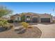 One-story house with a three-car garage, stone exterior and desert landscaping at 421 Foxhall Rd, Henderson, NV 89002