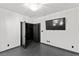 Simple bedroom with dark closet doors and a large TV at 4255 W State Highway 168, Moapa, NV 89025
