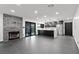Open kitchen with stainless steel appliances and stone fireplace at 4255 W State Highway 168, Moapa, NV 89025