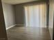 Bright bedroom with sliding door and wood-look flooring at 4471 Rich Dr # D, Las Vegas, NV 89102