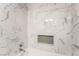 Clean bathroom featuring marble tile and a shower/tub combo at 4818 El Tesoro Ave, Las Vegas, NV 89121