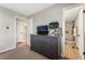 Bedroom with gray dresser, large TV, and access to a renovated bathroom at 4818 El Tesoro Ave, Las Vegas, NV 89121