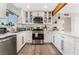 Modern kitchen with white cabinets, stainless steel appliances, and quartz countertops at 4818 El Tesoro Ave, Las Vegas, NV 89121