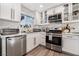 Updated kitchen featuring white shaker cabinets, stainless steel appliances, and quartz countertops at 4818 El Tesoro Ave, Las Vegas, NV 89121