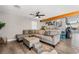 Spacious living room with sectional sofa and wood floors at 4818 El Tesoro Ave, Las Vegas, NV 89121